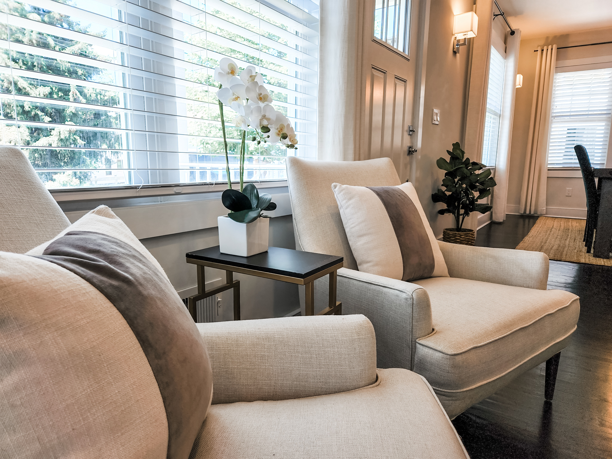 Monmouth-county-home-staging staged-sitting area in living room with neutral arm chairs, pillows and a plant