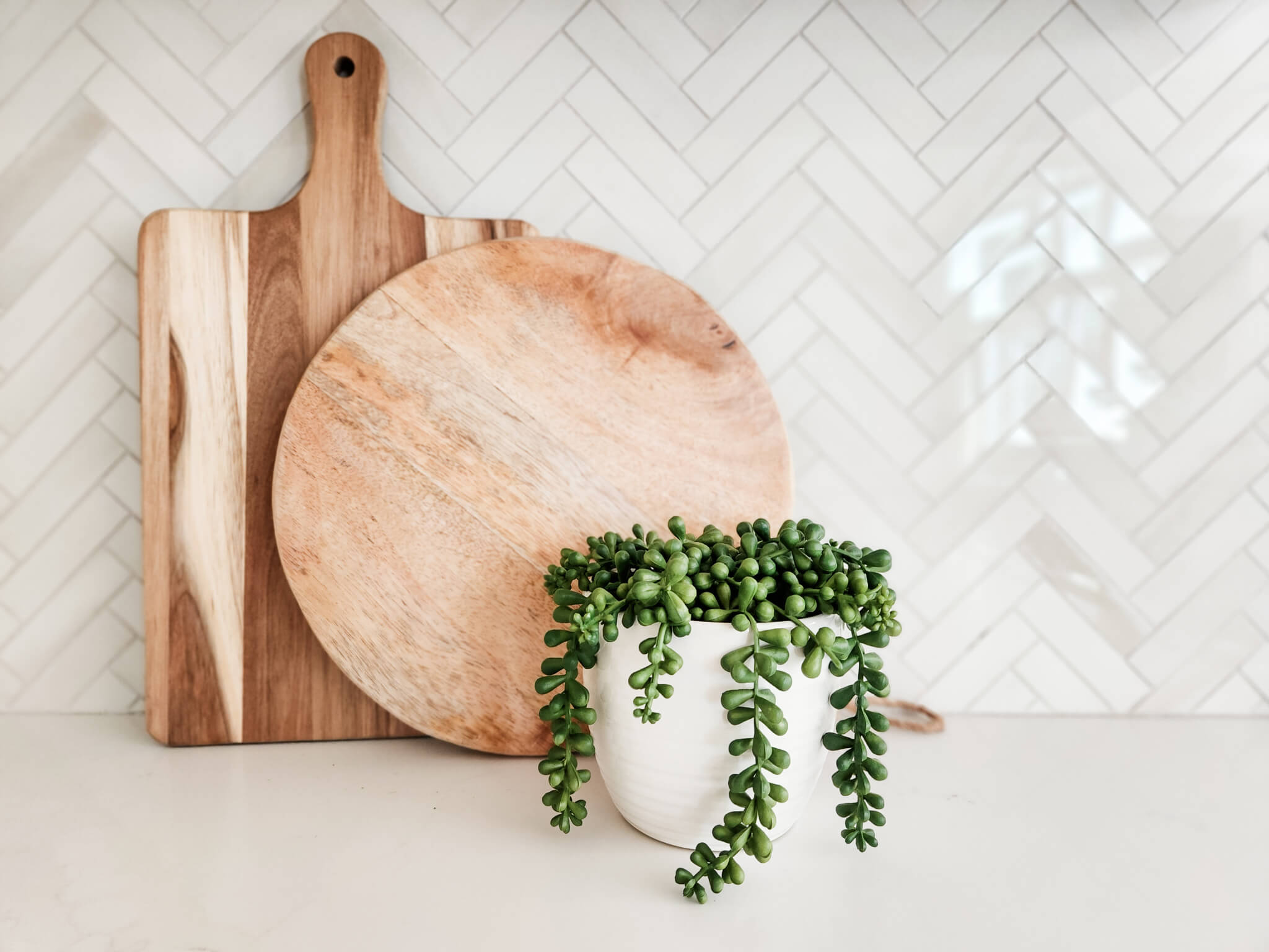 home staging kitchen vignette with plant and cutting boards